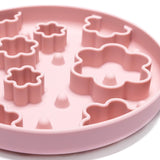 Close-up of pink Flower Power Slow Feeder Bowl showing raised flower-shaped texture for lick mat enrichment feeding.