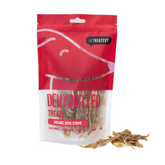 A package of The Treatery dehydrated organic duck strips dog treats, with some strips visible through the packaging window.