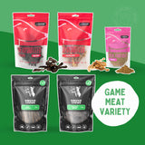 A variety of packaged dog treats, including Emu Strips, Goat Pizzle, Kangaroo Heart, Crocodile Jerky, and Kangaroo Meal Enricher, arranged on a green background with a 'GAME MEAT VARIETY' label.