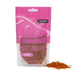 A pink package labeled 'MEAL ENRICHERS SALMON' with a visual representation of the product, which is salmon meal enricher powder, scattered in front.