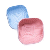 Square Puppy Lick Enrichment Bowls in pink and blue with raised textures promoting slow feeding and calm licking for puppies.