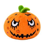 An orange plush pumpkin toy with a green stem, featuring a spooky embroidered face with large white eyes, black stitched details, and small decorative accents on a plain white background.