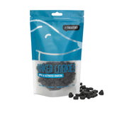 A package of The Treatery's Apple & Activated Charcoal dog cookies, with some cookies visible outside the package.