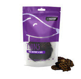A package of Beef, Beetroot & Basil Thins dog treats by The Treatery. The packaging is purple with a transparent window showing the wafer disc dog treats inside.