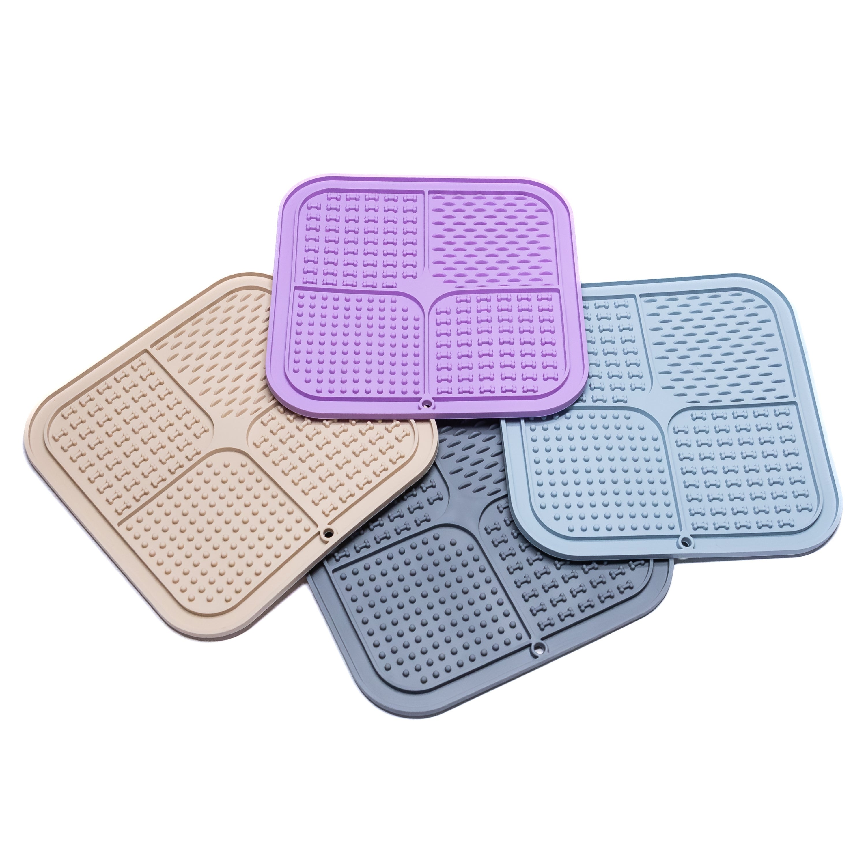 Assorted pastel FourZone Slow Feeder Enrichment Mats for dogs promoting healthy digestion, slow eating, and stress relief.