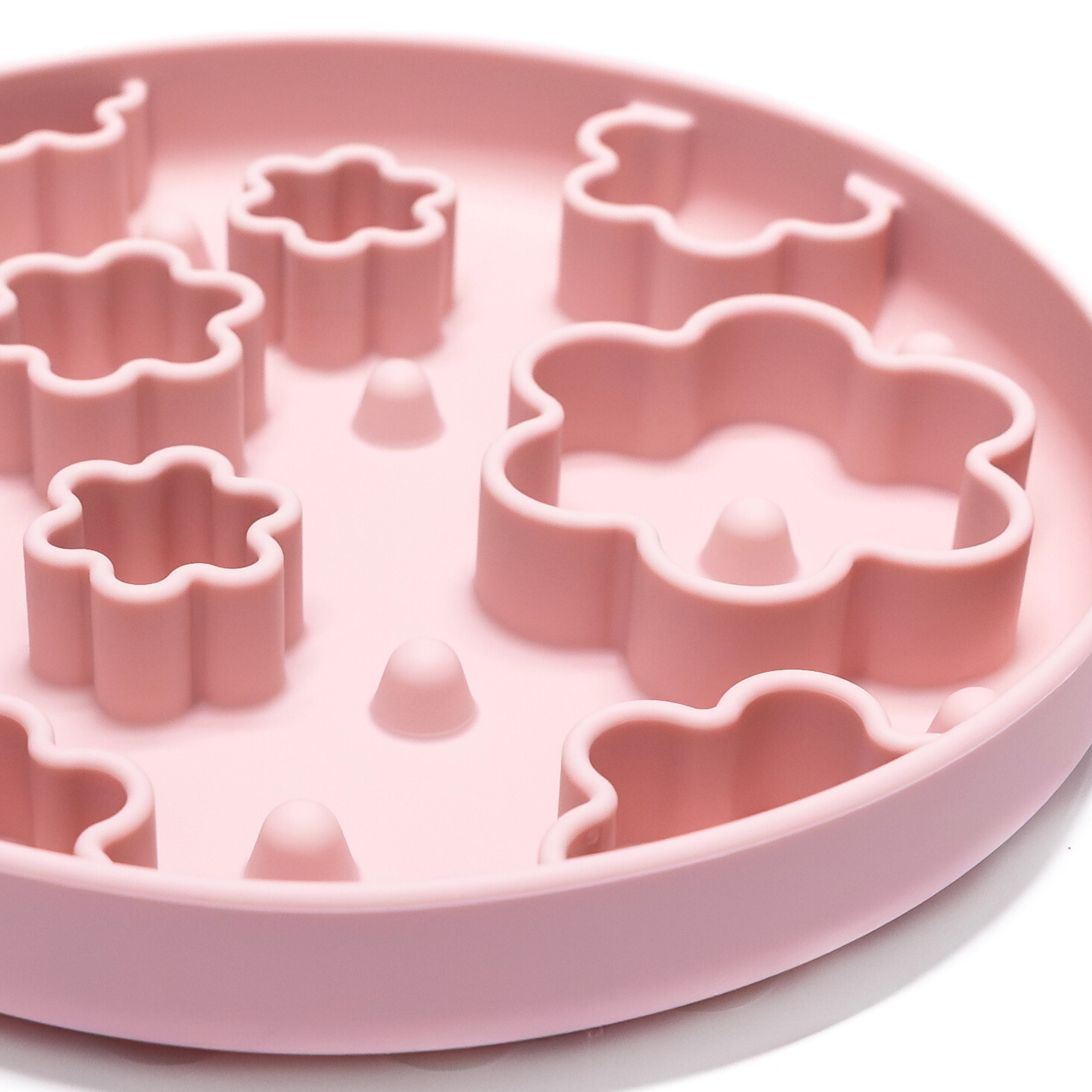 Close-up of pink Flower Power Slow Feeder Bowl showing raised flower-shaped texture for lick mat enrichment feeding.