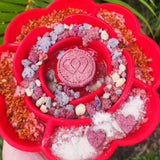 Close-up of red Rose Flower Slow Feeder filled with colorful treats encouraging dogs to lick and eat slowly for better digestion.