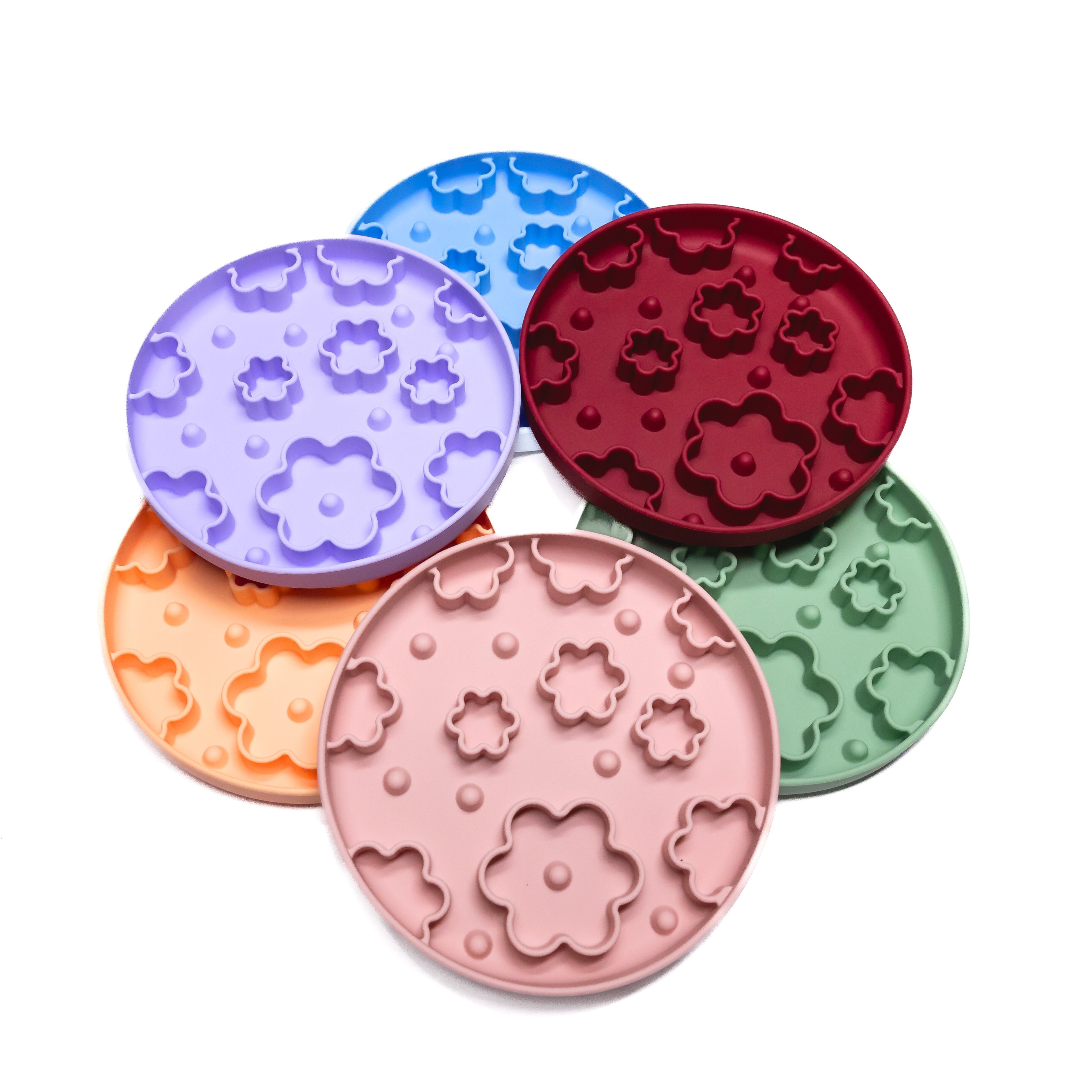 Flower Power Slow Feeder Enrichment Bowls in assorted pastel colors designed to promote slow eating and mental stimulation in dogs.
