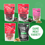 A variety of packaged dog treats, including Emu Strips, Goat Medley, Kangaroo Heart, Crocodile Jerky, and Kangaroo Meal Enricher, arranged on a green background with a 'GAME MEAT VARIETY' label.