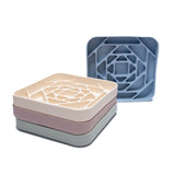 Geometric Slow Feeder Enrichment Bowls in stack of pastel colors designed with maze pattern to promote slow feeding for dogs.