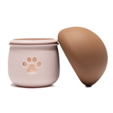 Mushroom-shaped Dog Treat Dispenser with removable brown top and paw print opening for interactive feeding and anxiety relief.