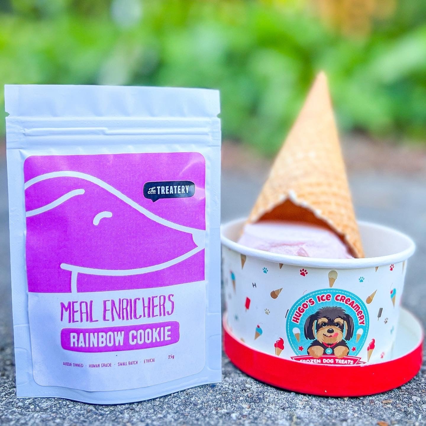 Rainbow cookie meal topper blend for dogs beside Hugo’s Ice Creamery frozen dog treats