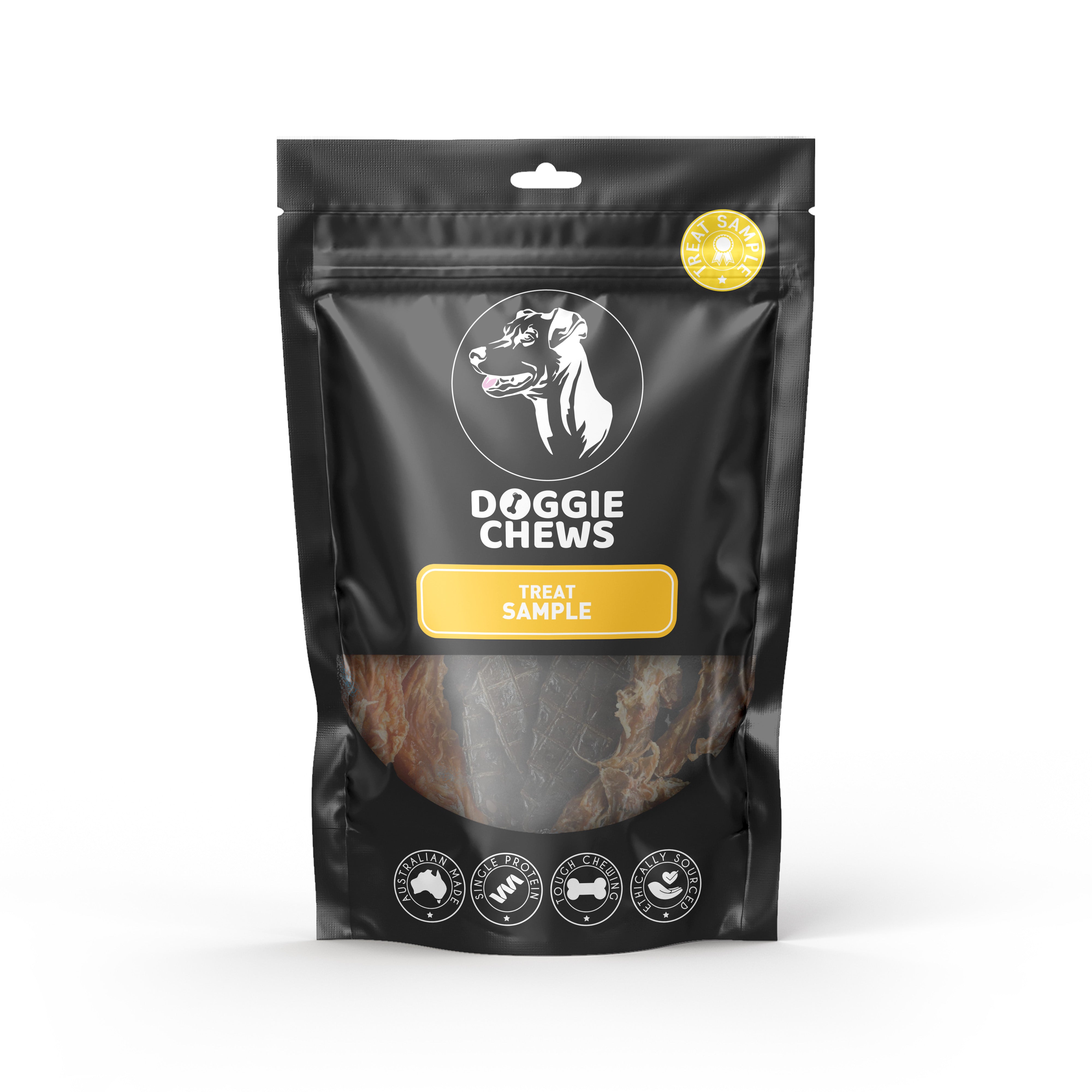 A sealed, black plastic packaging with a clear window showing treat samples inside. The packaging has a white and yellow label with the brand 'Doggie Chews' and text indicating it is a treat sample pack.