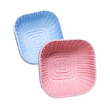 Square Puppy Lick Enrichment Bowls in pink and blue with raised textures promoting slow feeding and calm licking for puppies.