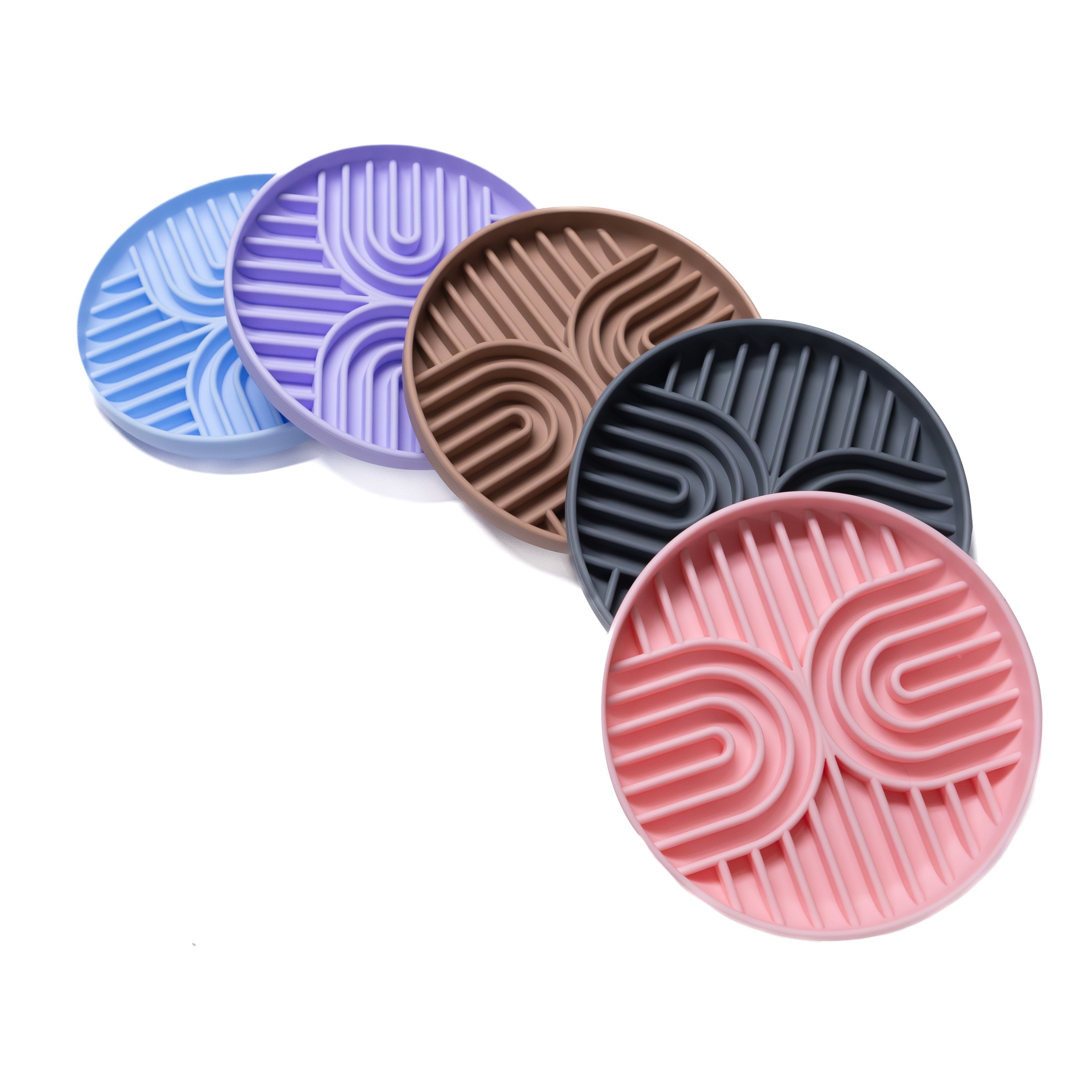 Stack of Double Rainbow Slow Feeder Bowls in assorted colors for enrichment feeding.