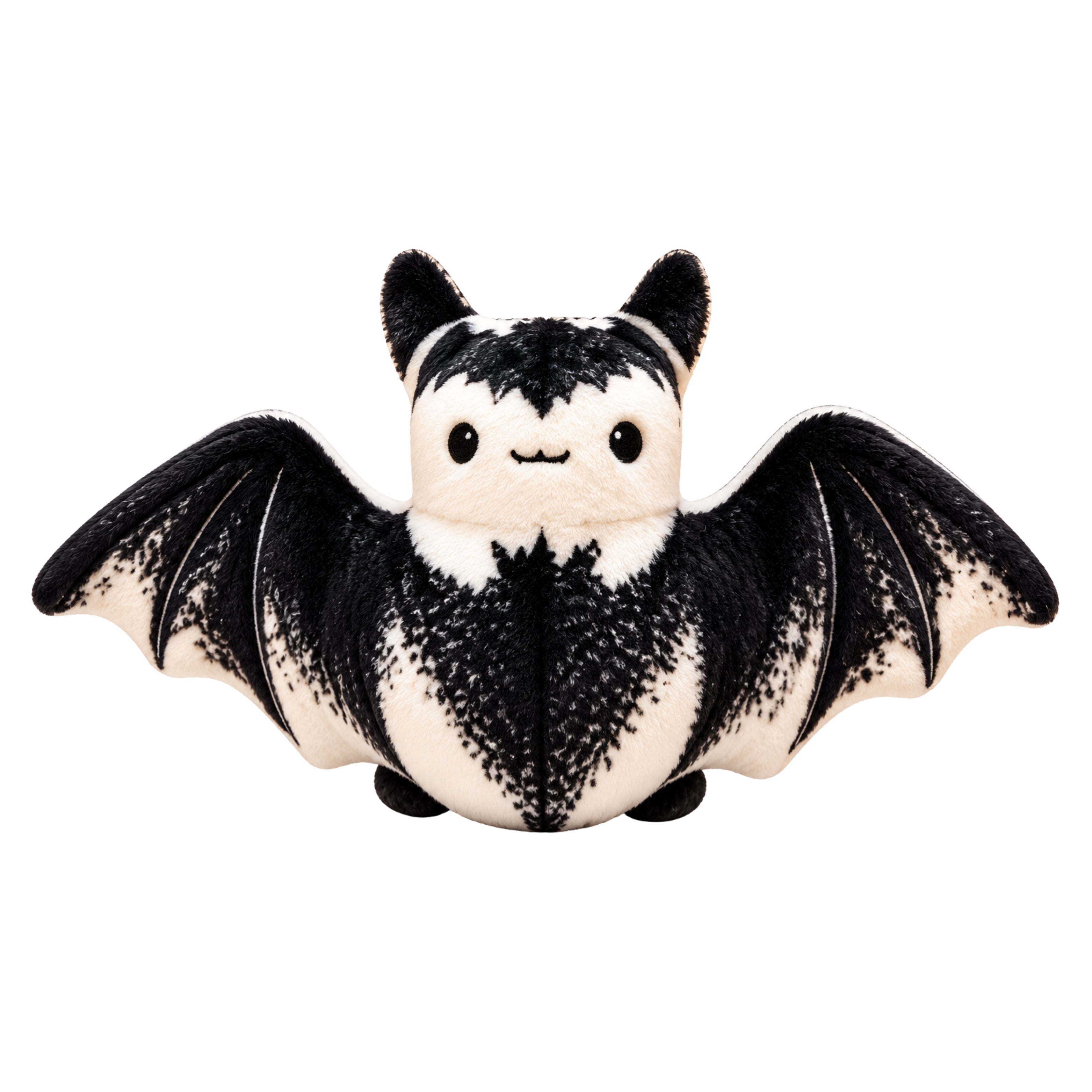 A cute plush bat toy with black and white fur, spread wings, and a smiling face, isolated on a white background.