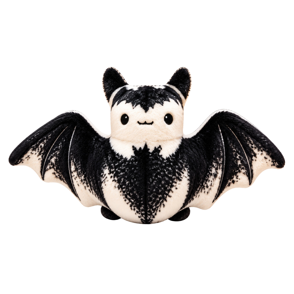 A cute plush bat toy with black and white fur, spread wings, and a smiling face, isolated on a white background.