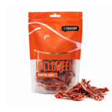 Packaging of Monster Jerky Halloween dog treats from The Treatery, with single protein chicken jerky pieces displayed in front.